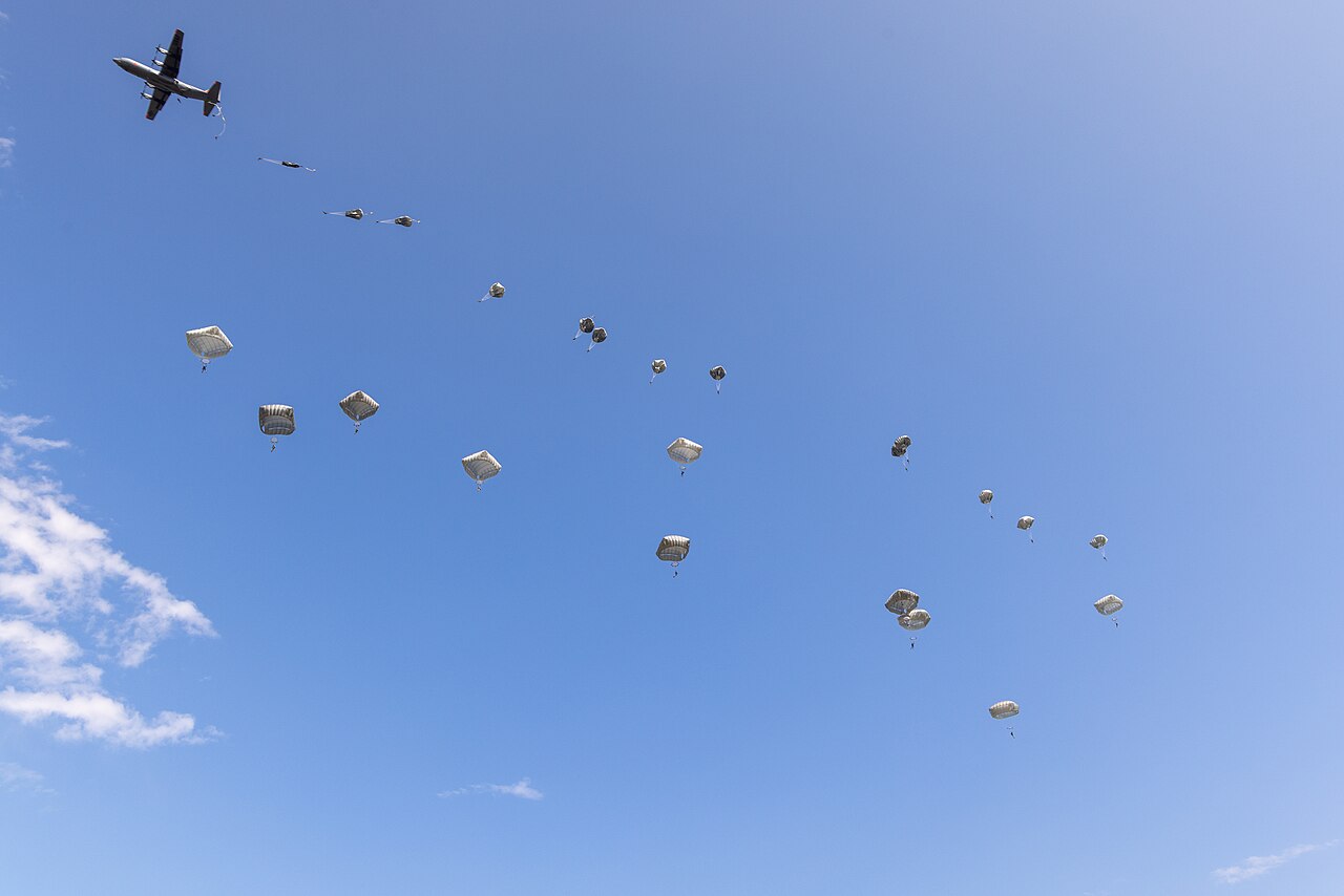 Paratroopers of the 173rd Airborne Brigade descend from a C-130 during an airborne operation