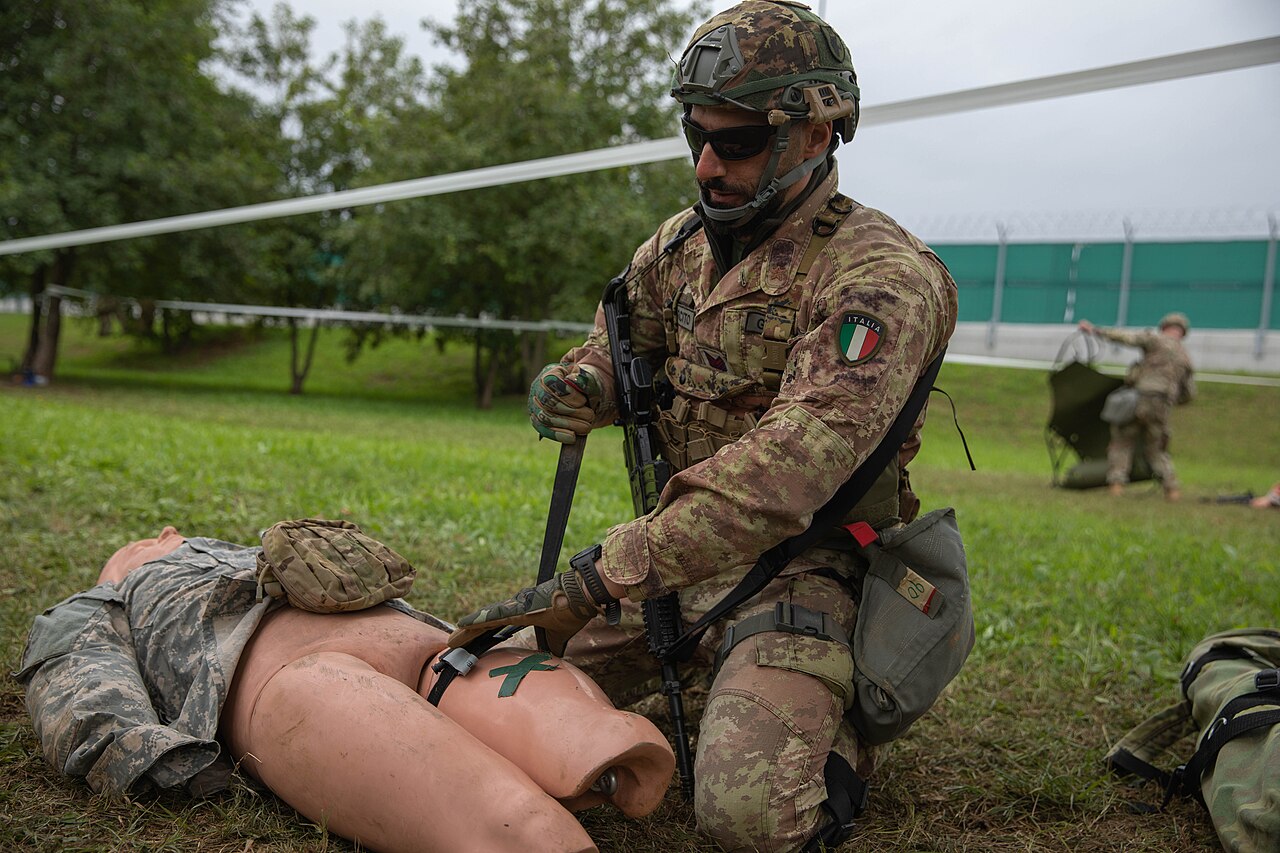 An Italian soldier treats a training mannequin during expert medic testing at Caserma Del Din
