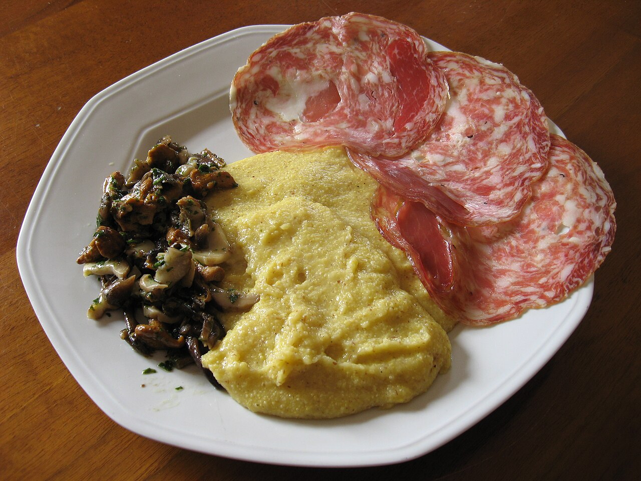 Grilled polenta topped with sopressa and mushrooms